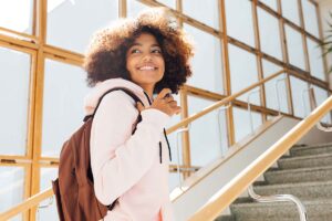 a young person walks up stairs and smiles back while going to ADHD treatment