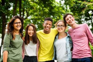 a group of teens smile at the camera after learning about Adolescent Therapy Programs