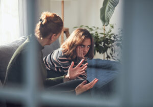 parent and adolescent discussing the benefits of anger management programs