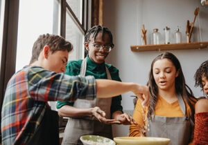 adolescents in life skills training program learning how to cook together