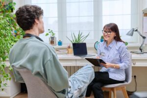 teen learning about medication management in session with counselor 