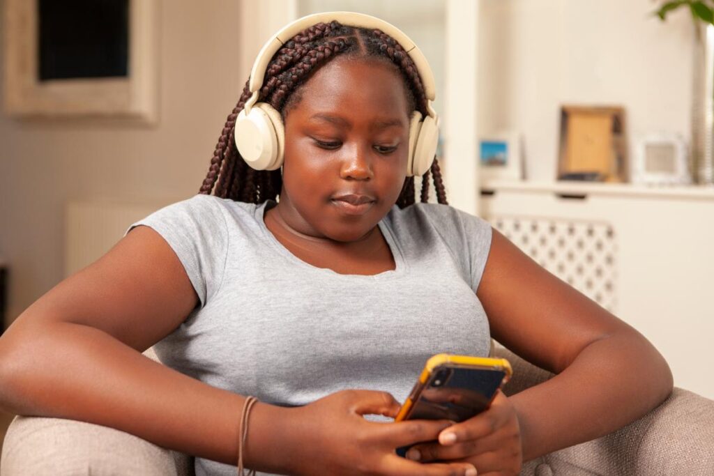 teen using headphones and meditation app after learning about activities to help with anxiety